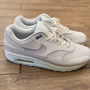 Nike Air Max light gray and white with blue accents.